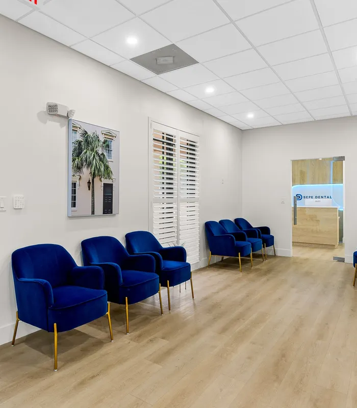 Sepe Dental waiting room with blue velvet seating in Delray Beach, FL