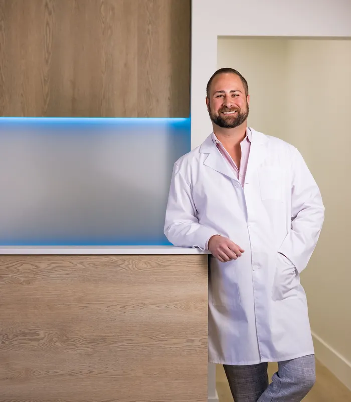 Dr. Christopher Sepe at the front desk of Sepe Dental in Delray Beach, FL